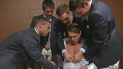 Busty brunette in front of a group of guys in hot porn video